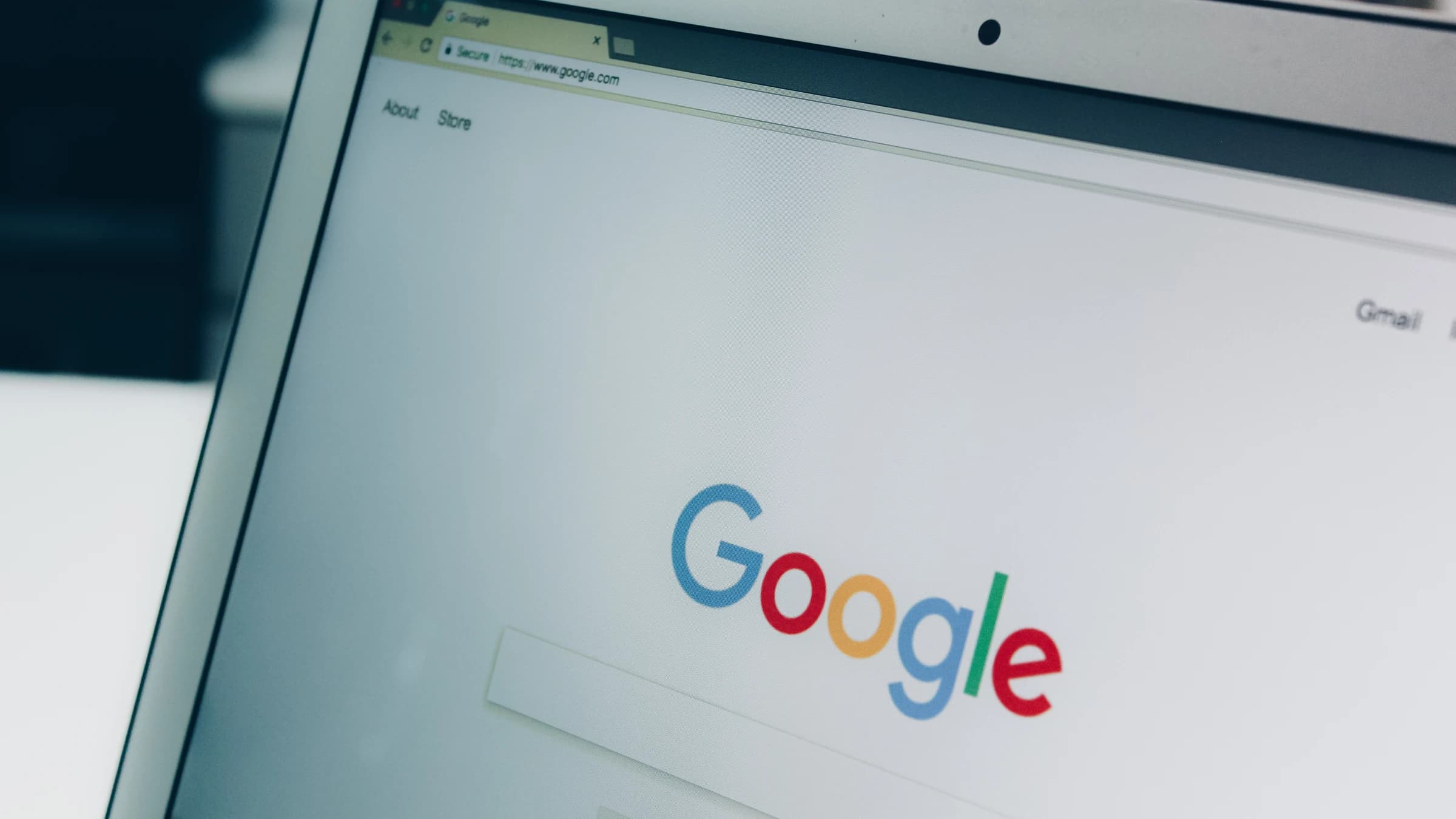 The Google Search homepage open on a laptop screen, with the Google logo above the empty search box.